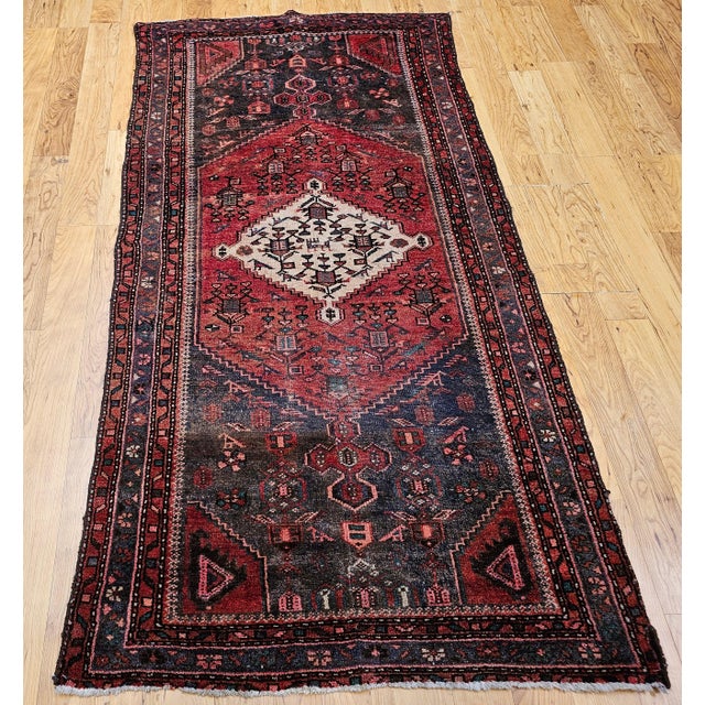 This beautifully handwoven vintage Persian Hamadan area rug dates to the early–mid 20th century and exemplifies the...