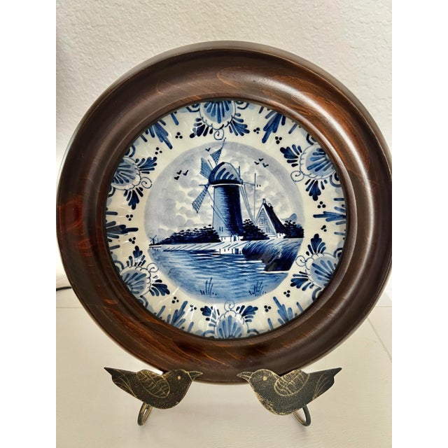 Decorated in a traditional Dutch blue and white motif with windmill, this framed collectible danish plate includes the...