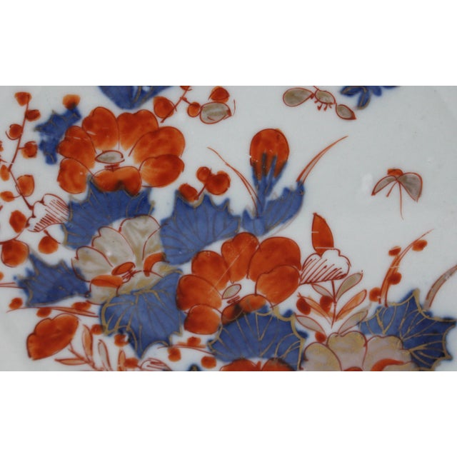Circa 1860 reticulated ribbon border Imari plate, Japan. Large, sweeping Imari palette asymmetrical floral reserve. Some...