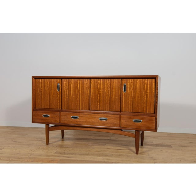 Sideboard made in teak designed by Victor Wilkins for G-Plan in the 1960s. Completely restored. Teak elements have been...
