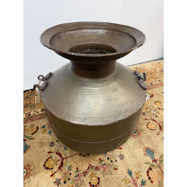 Design Plus Gallery presents a Cooper Water Vessel with Rope Handles. This vessel has a rounded body, flared rim, hammered...
