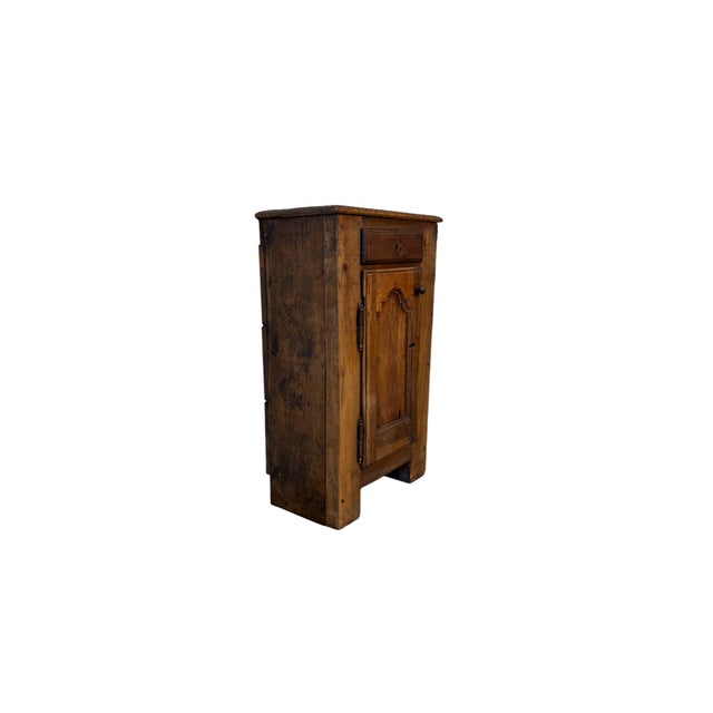 Small sacristy cabinet in walnut wood from the 1700s, characterized by an upper molded door and a practical lower drawer....