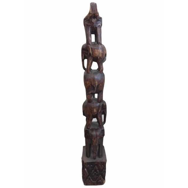 Who doesn't love elephants? Good luck. This sculpture is solid and intricately carved from a log of solid wood. Brings an...