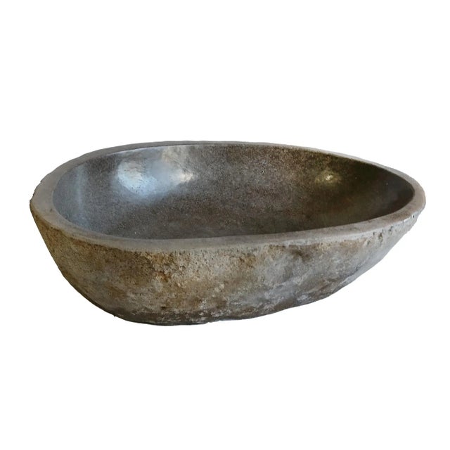 A solid stone sink or basin, hand-crafted in Indonesia. Organic modern style. Carved from volcanic rock, the outside of...