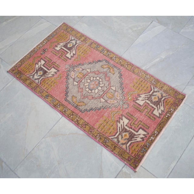 a Vintage Turkish Small yastik rug, rose color background rug perfect for entryway, bath or in front of the kitchen sink....