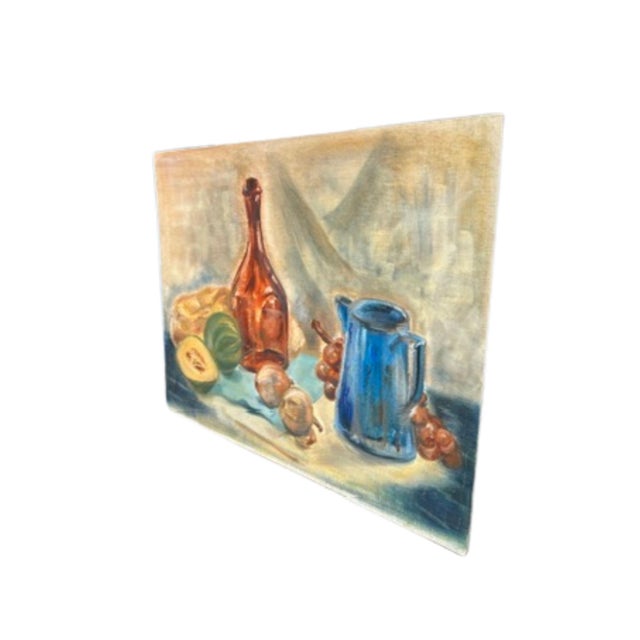 An unframed vintage still life on canvas, with an amber glass bottle stands at center, flanked by a pale round loaf or...