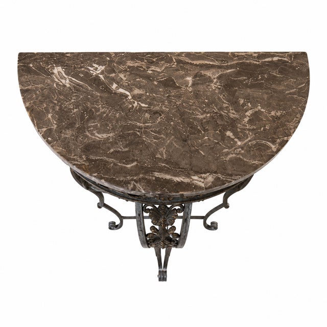 This French Art Deco demilune console table (circa 1920) blends sculptural steelwork with a polished gray‑and‑white marble...