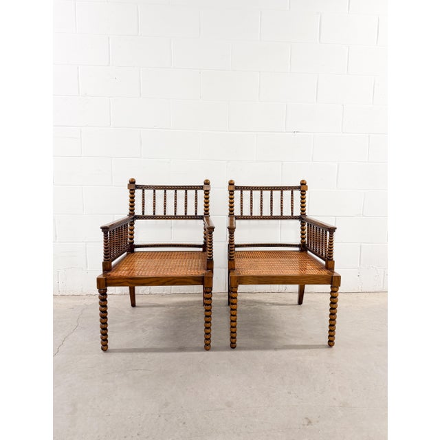 A charming pair of vintage bobbin-turned armchairs, probably from the mid-20th century (1960s-1970s), offers a lovely...