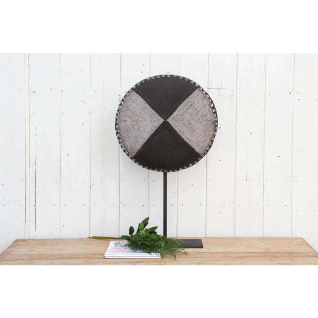 Beautiful African tribal round shield, meticulously hand-crafted from native hardwood and adorned with intricate beadwork...