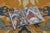 Hand-knotted in wool, this antique 5x14 Chinese Ningxia pillar runner from circa 1920–1939 features an elaborate pictorial...