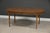 A mid century modern walnut oval dining table with two 18” leaves that fully expand the table to 104” by Thomasville...