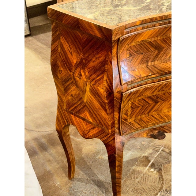 The 19th c. Italian Walnut Bombe Side Table is a charming piece of furniture with an inlaid pattern and a marble top. A...