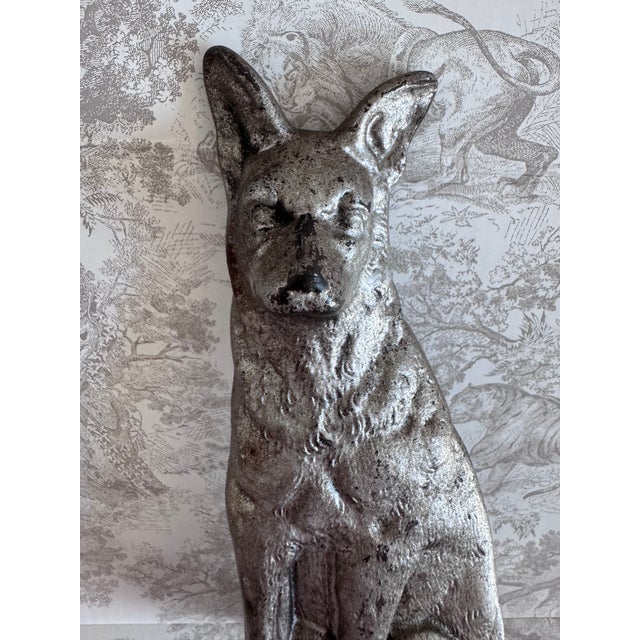 A charming fox to keep the door from swinging closed. Made of cast iron and painted silver. Has wear typical of age.