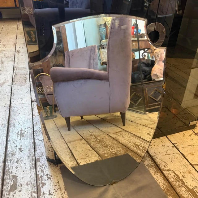 This elegant 1950s Italian wall mirror captures the quintessential spirit of Mid-Century Modern design, heavily influenced...