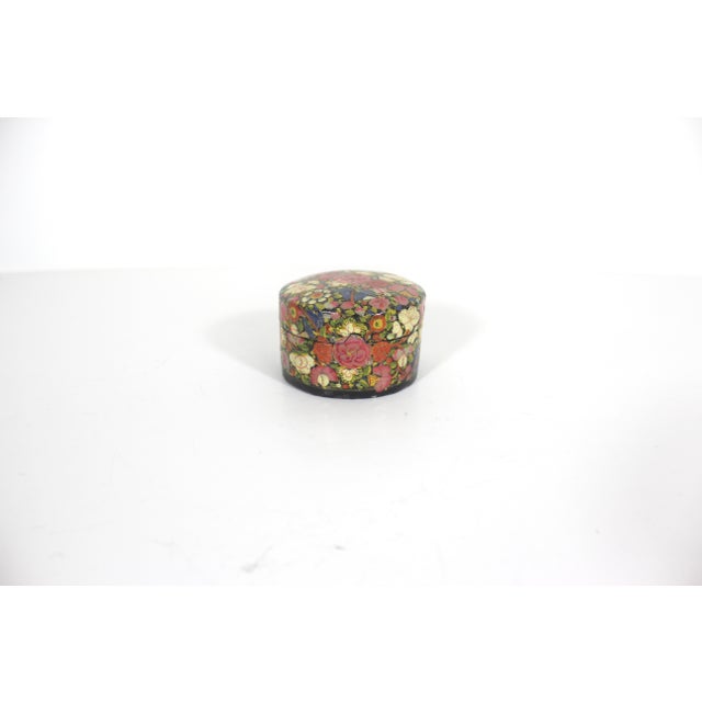 Beautiful vintage Kashmir lidded round trinket box made from papier maché, hand painted and then lacquered. This has a...