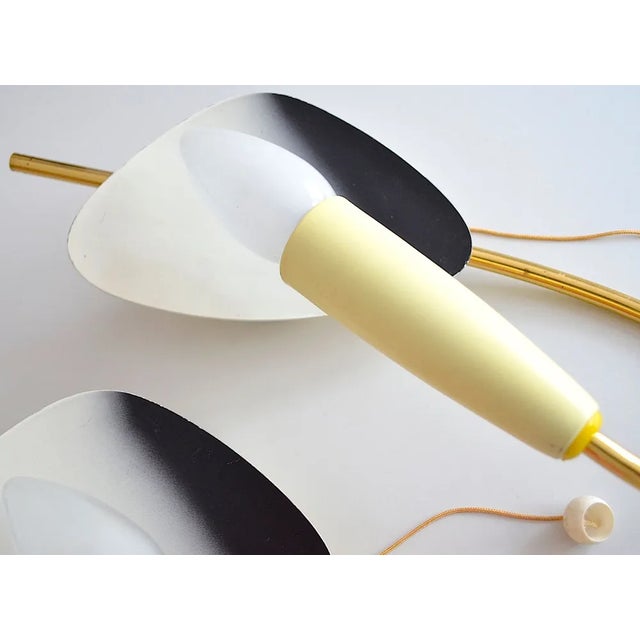 A pair of kidney shaped wall lamps from the 1950s. Each lamp features a pull switch. Up to 250V (Europe/UK Standard).The...