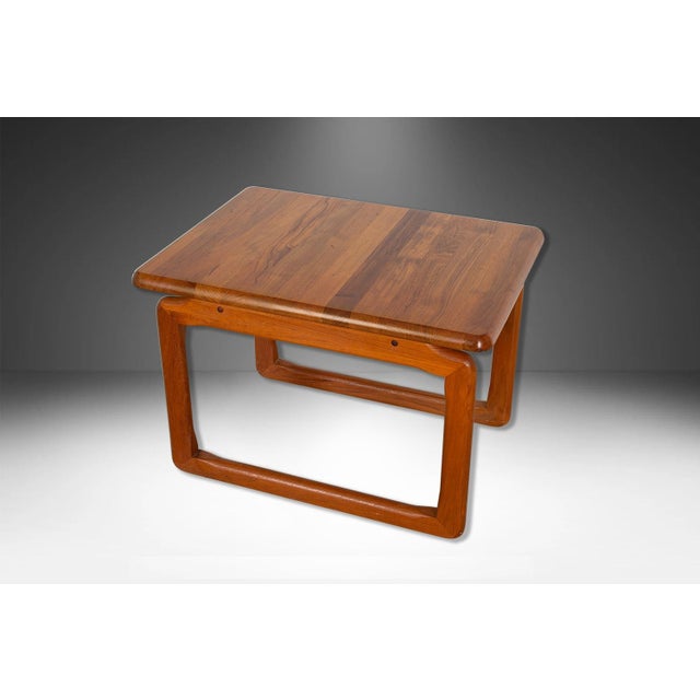 A beautiful teak end side table by Tarm Stole Mobelfabrik A/S. Featuring stunning, signature sculptural design, with...