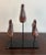 Set of three wooden child size shoe forms mounted on an iron base.