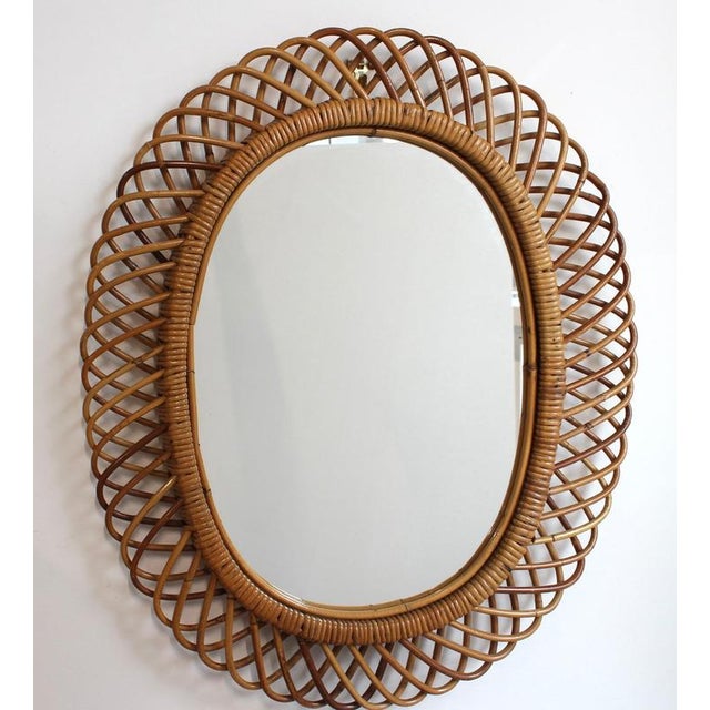 Rattan wall mirror (circa 1960s) in that inimitable italian style that is so loved. This mirror has a complex weave of...