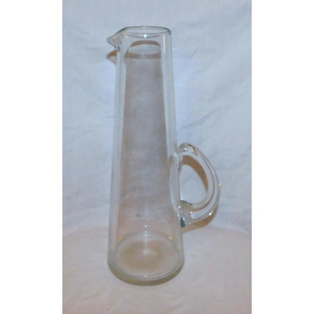 Classy MCM cocktail set with sleek pitcher and 11 small cups with detachable metal handles. Pitcher measures 12.5" x 5" x...