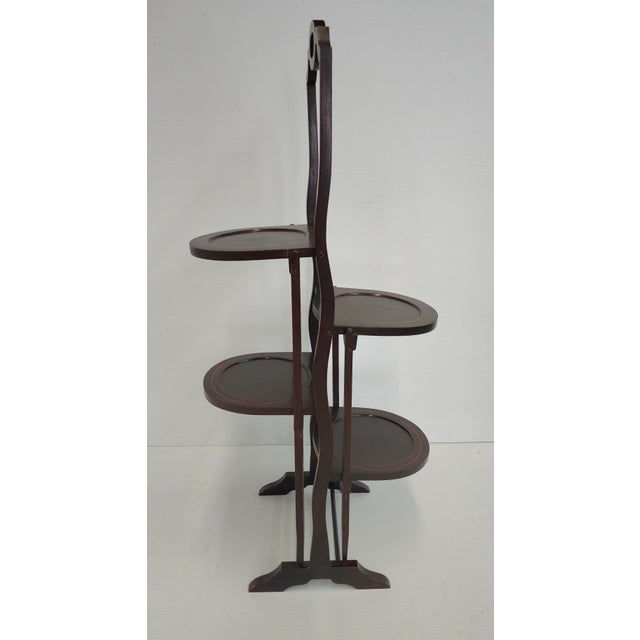Antique Edwardian Mahogany Folding Cake Stand, circa 1880-1890. Measures 19" in width, 10 " in depth and 37" in height....