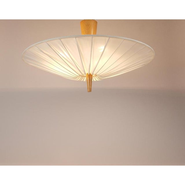 A minimalist yet elegant flush-mount light fixture (plafoniere / chandelier) from the 1950s. Model no. 5178, manufactured...