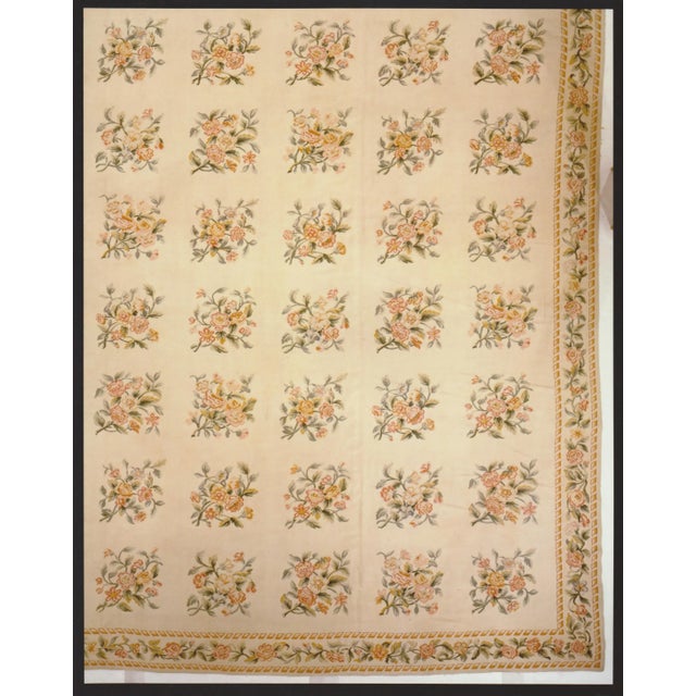 Aubusson palace size carpet. An unusually restrained French Aubusson carpet in a continuous pattern of floral squares on a...