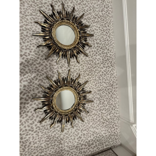 Gorgeous vintage gilt sunburst mirrors, sold as a matching pair. These pieces date to the 1960s and feature a classic...