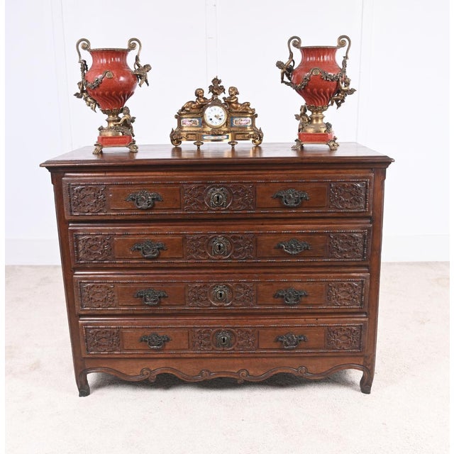 A handsome French Normandy carved oak chest of drawers dating to around 1780. The chest features rich hand-carved...