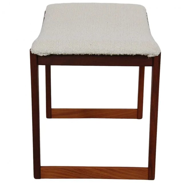 Danish footstool of teak and with upholstery of white wool fabric. The stool is from the 1960s, but appears completely...