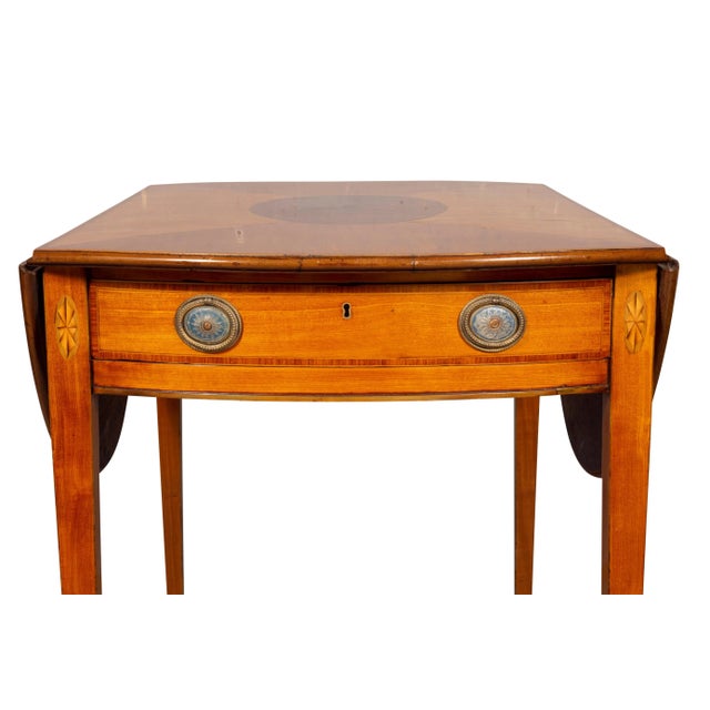 Rectangular top with D shaped hinged leaves, the center and leaves with oval inlay over a frieze containing a conforming...