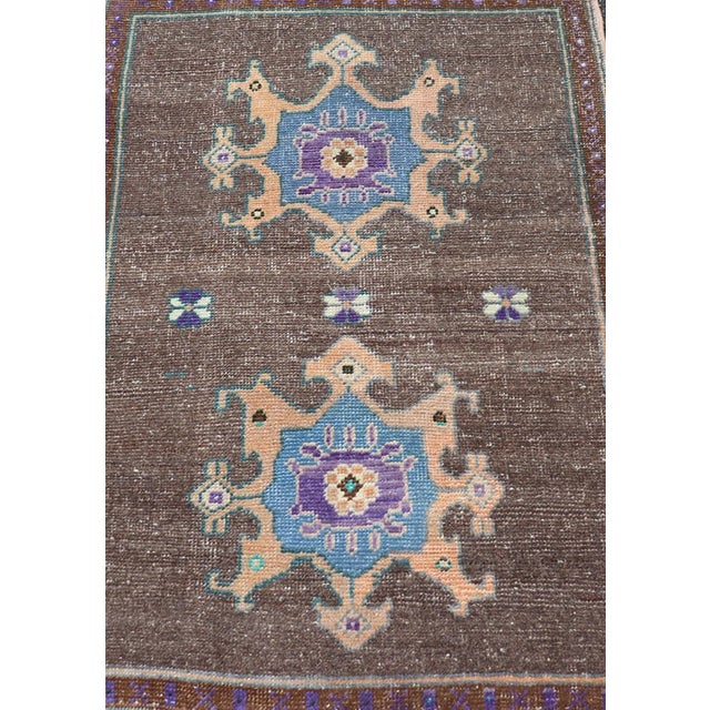 Measures: 2'7 x 3'7 This exquisite Vintage Turkish Oushak rug showcases a rich brown background beautifully contrasted by...