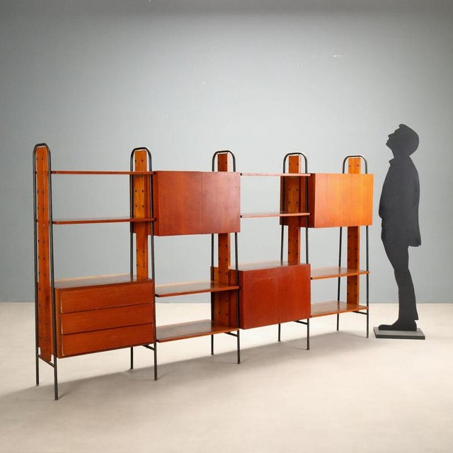 Vintage 1960s bookshelf with a freestanding design, ideal for placement even in the center of a room. Made of teak veneer...