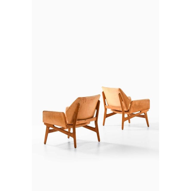 This exceptionally rare pair of easy chairs, designed in 1954 by erik ostermann and produced by georg jørgensen & son in...