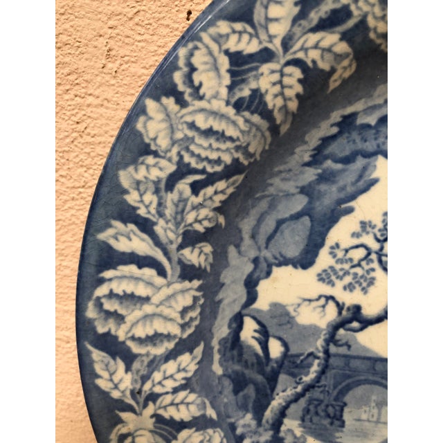 Early 19th century blue and white transferware plate with castle, bridge with a flower border signed Clews Staffordshire....