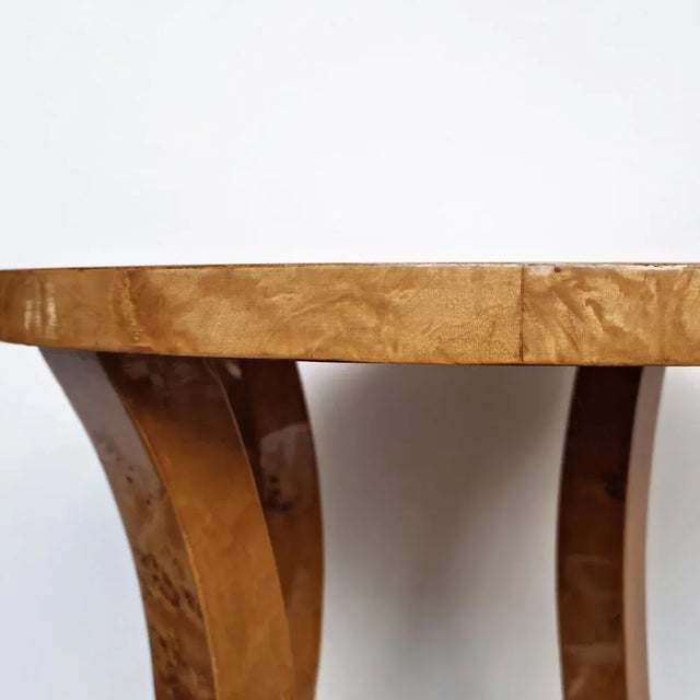 Italian Art Deco-style gueridon table from the 20th century, featuring a burled wood veneer with a meticulously crafted...