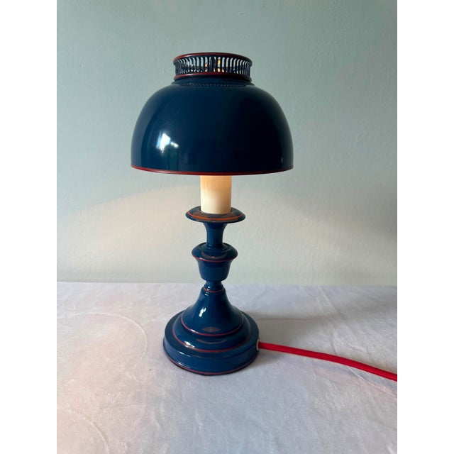 This is a Mid Century Modern 1960’s table lamp with tole painting red on blue. New red silk wiring. Original pieces and...