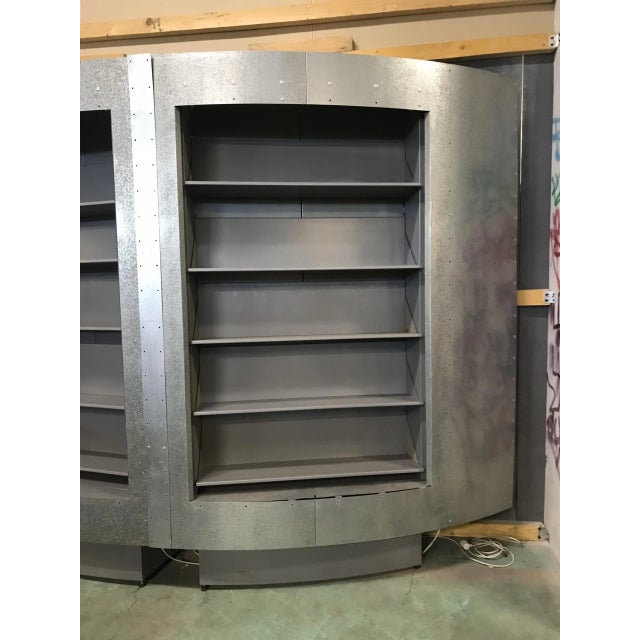 This bookcase is made of galvanized steel. It can be dismantled into two parts and has a lighting system around the...