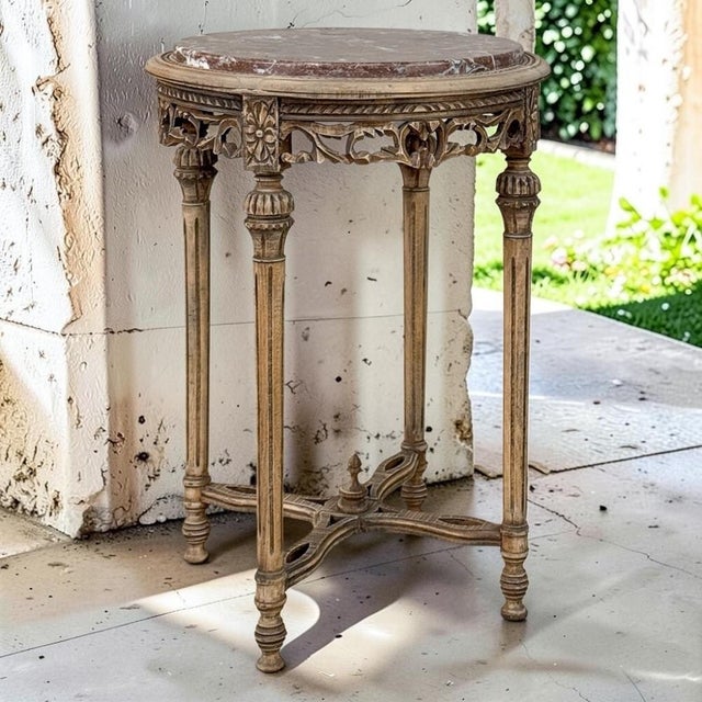 French Louis XVI Stripped Marble Top Occasional Table presents an exceptionally graceful interpretation of the...