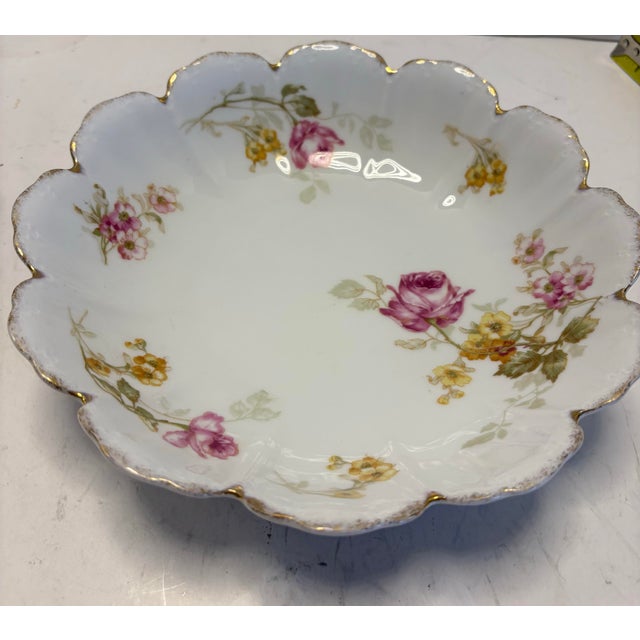 An elegant early 20th-century Bavarian porcelain bowl by Malmaison, decorated with hand-applied floral sprays and finished...
