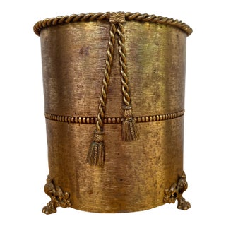 Midcentury Hollywood Regency Gold Tone Wastebasket With Rope and Tassel Detail and Claw Feet For Sale