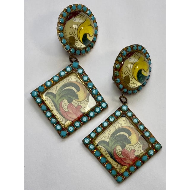 Clip-on costume drop earrings from the 80s. These are laminated printed paper under clear acrylic on a metal frame. Very...