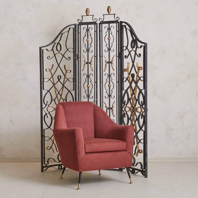 A pair of 1930s French Art Deco screens in the manner of Gilbert Poillerat, crafted in wrought iron with sinuous,...