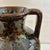Tall speckled ceramic urn vase. The base color is brown and it has flecks and speckles in varying shades of greens. Great...