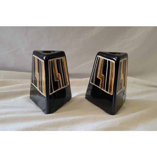 Pair of triangular shaped ceramic candleholders by Harris Potteries, Chicago, IL. They are glazed with black and gold...