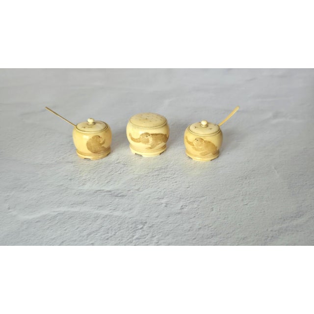 A rare and charming Japanese three-piece carved ivory set dating to the late Meiji period, circa 1880–1910. Finely turned...