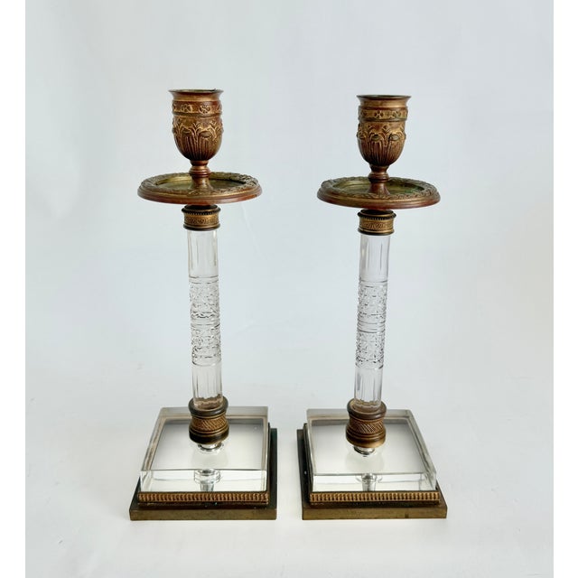 This rare pair of French Restoration period (circa 1820-1830) candlesticks beautifully blend classical elegance and...