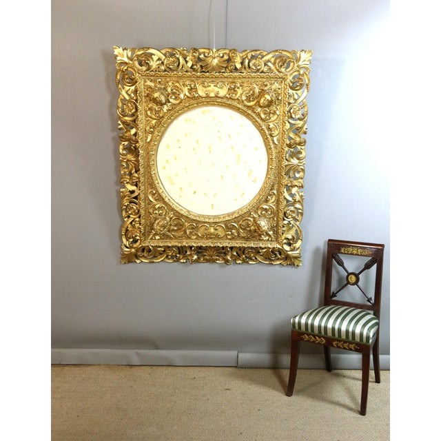 Very large gilded carved wooden frame from the early 20th century. This openwork frame is adorned with four women's heads....