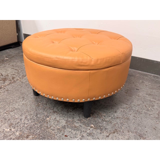 Design Plus Gallery presents a Storage Ottoman from Partner Furniture. Upholstered in light brown faux leather, the...