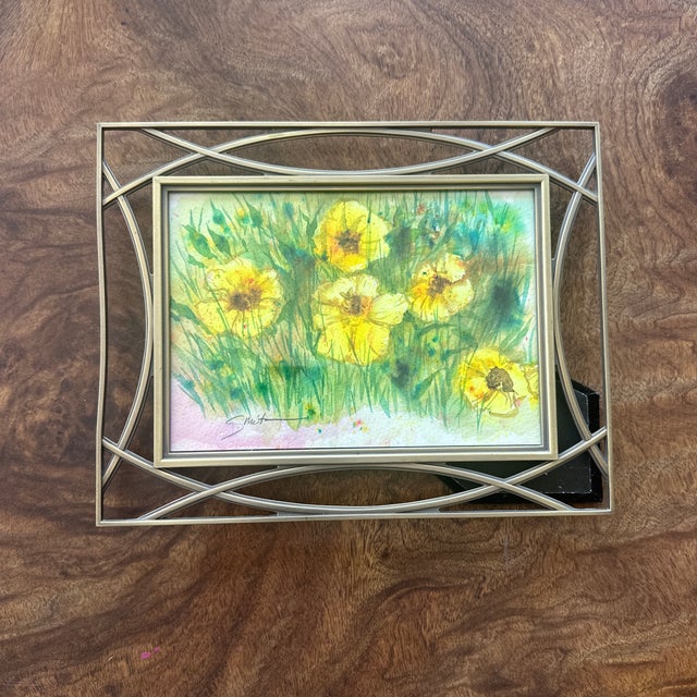 Bursting with life, this expressive floral watercolor features bright yellow blossoms dancing amid lively green grasses....